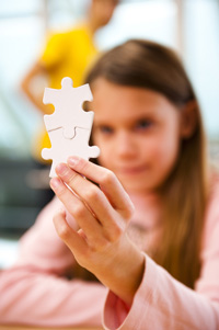 GirlHoldingPuzzlePieces Web