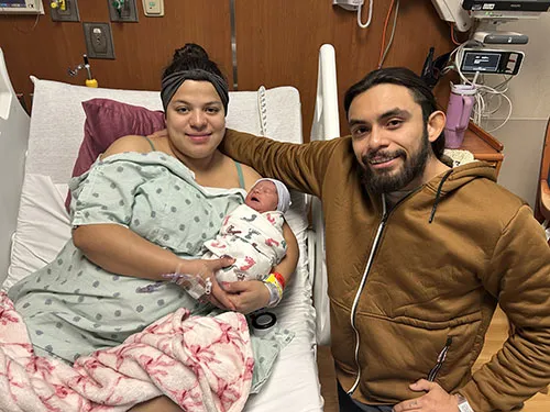 Parents Claudia Flores-Rios and Erik Flores hold their new baby girl, Oulahni